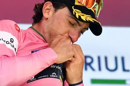 Giulio Ciccone kisses the leader's maglia rosa
