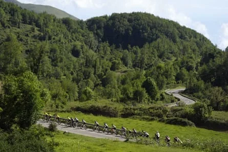 The peloton passes through green hills